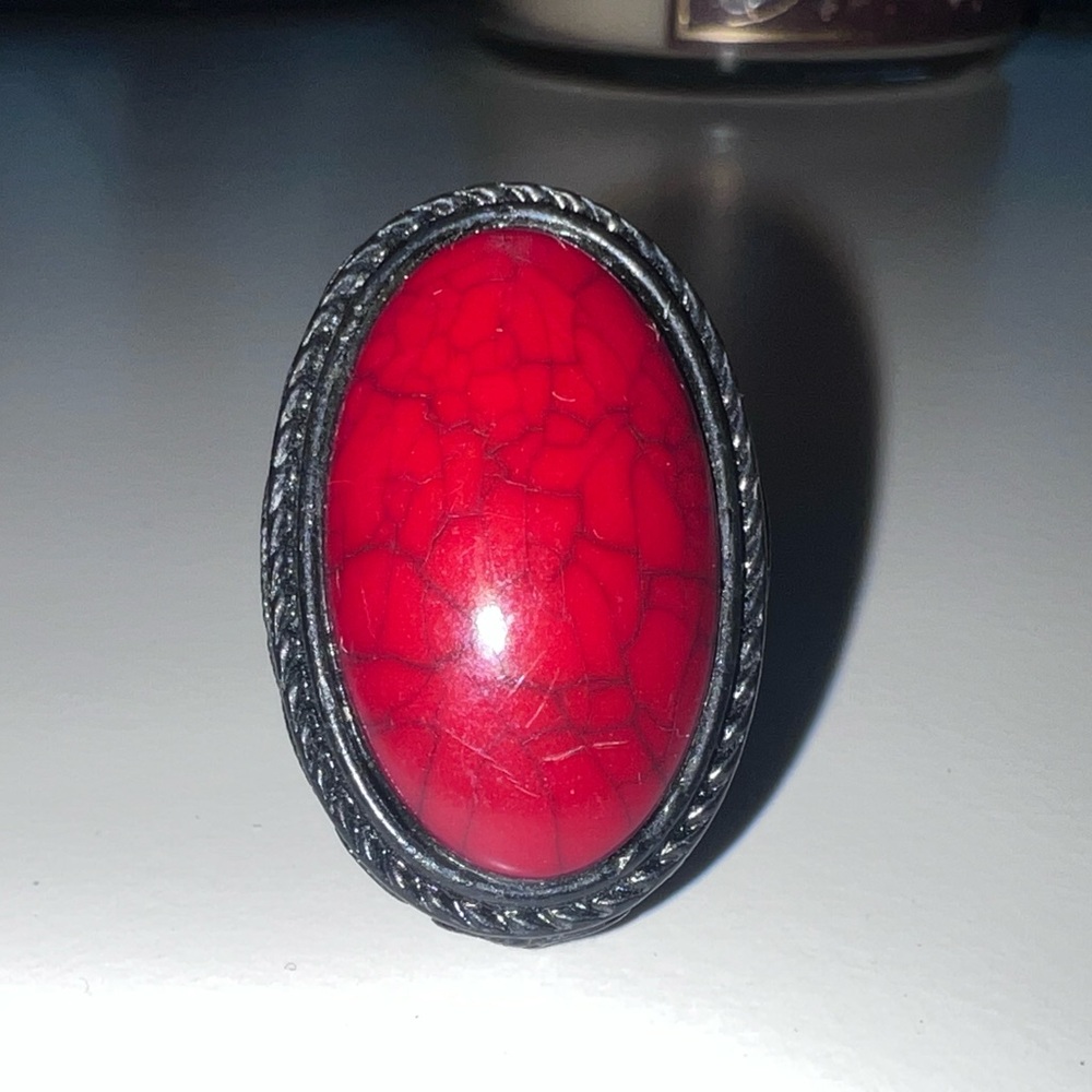 Large oval red cabochon stone with dark-toned metal finish. Size 10.